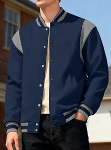 Detailed view of a men's navy blue and grey color-block varsity jacket worn outdoors