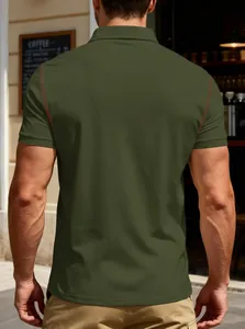 Back view of a classic olive green men's short sleeve polo shirt in a cafe setting