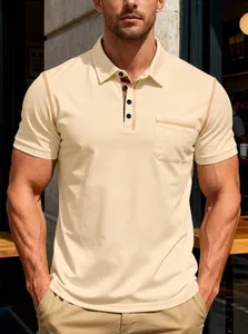 Close-up detail of a men's beige polo shirt featuring contrast yellow stitching and a front pocket