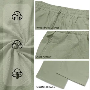 Dettaglio dei pantaloni in misto lino verde salvia con cintura e cuciture di qualità.