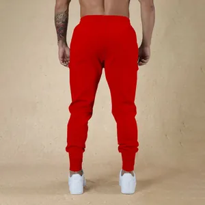 Vista posteriore di pantaloni sportivi rossi da uomo muscle fit con polsini a costine