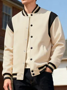 Close-up of casual men's color-block varsity jacket with snap buttons and stand collar.