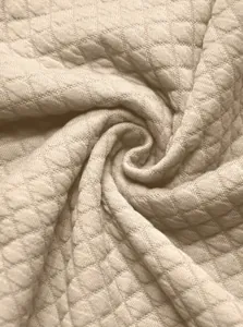 Macro detail of high-quality waffle knit jacquard fabric for men's casual jacket.