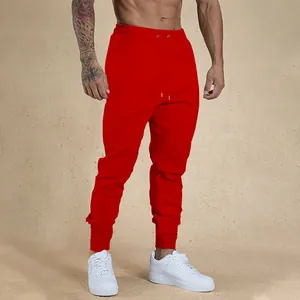 Men's red fitness joggers with elastic waist and ribbed cuffs for gym and running