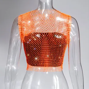 Close-up detail of orange rhinestone fishnet crop top with sparkling crystals for clubwear