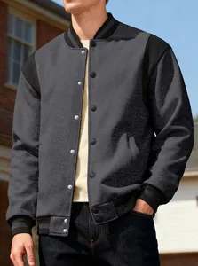Detailed view of men's grey and black color block varsity jacket with button front