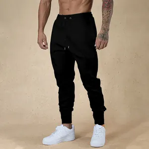 Slim fit black joggers for men showing elastic drawstring waist and cuffed hem detail