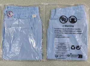 Detail view of light blue linen casual shorts in protective plastic packaging bags