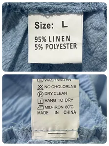 Close-up detail of the care label and material composition for blue men's linen shorts