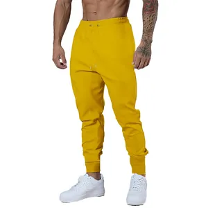 Front view of men's bright yellow muscle fitness joggers with a comfortable drawstring waist