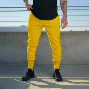 Vibrant yellow men's slim fit joggers with drawstring waist for fitness and workout