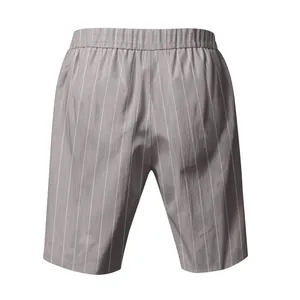 Detailed close-up of men's grey vertical striped linen beach shorts with elastic waistband