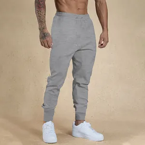 Premium grey slim-fit men's fitness joggers featuring drawstring waist and ribbed cuffs.