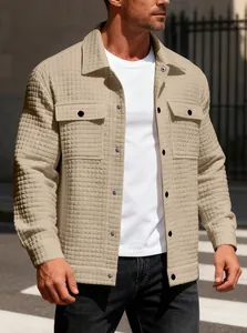 Close-up of men's beige waffle knit jacket with textured pattern and flap pockets