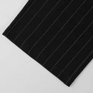 Close-up of black pinstripe linen fabric on breathable men's casual beach trousers