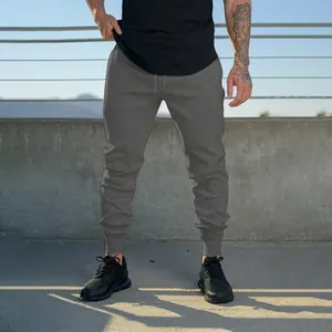 Detailed view of men's slim-fit grey sports joggers for gym and casual outdoor wear