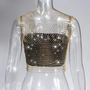 Macro detail of a sexy gold fishnet rhinestone vest, perfect for nightclub and party wear.