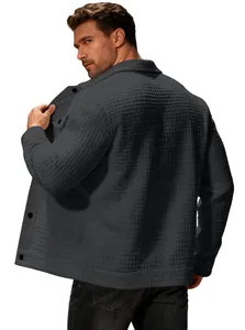 Detail view of the back of a grey waffle-knit jacket showing fabric texture and fit