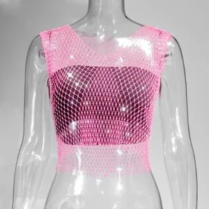 Detail view of a pink fishnet mesh crop top embellished with sparkling silver rhinestones.