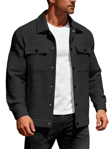 Close-up detail of a men's black waffle-knit single-breasted jacket with flap pockets.