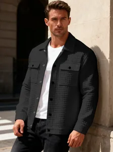 Detail of men's black waffle-knit jacket with quilted texture and chest pockets.