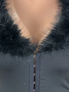 Detailed view of sexy black jumpsuit featuring a plush fur collar and hook closure.
