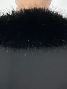 Detailed view of the soft black faux fur collar on the slim-fit evening jumpsuit.