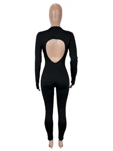Back view detail of a sexy black long-sleeve jumpsuit featuring a large heart-shaped cutout