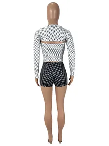 Back view of three-piece sexy polka dot long-sleeved shrug and high-waisted shorts set for women