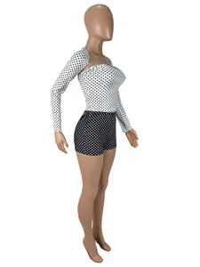 Side view of woman's three-piece set featuring polka dot shrug, tube top and shorts