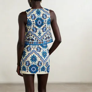 Back view of stylish blue floral print two-piece set with sleeveless top and mini skirt.