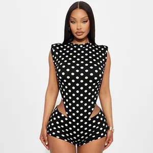Close-up detail of a polka dot sleeveless romper with sexy side cut-outs in black and white