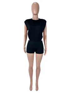 Front view of black round neck sleeveless cutout bodysuit and tight shorts set on mannequin