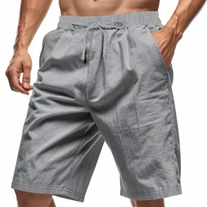 Detail of men's grey linen shorts featuring drawstring waist and breathable fabric texture.