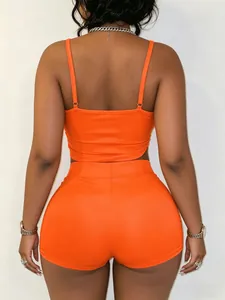Back view of a sexy orange two-piece set with adjustable straps and matching tight shorts.