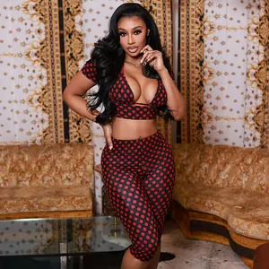 Sexy two-piece red and black polka dot crop top and capri leggings set on fashion model