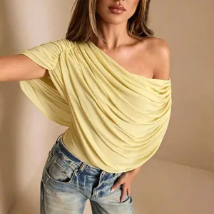 Detail shot of a sexy pale yellow one-shoulder pleated bodysuit for women's fashion