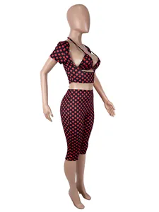 Side view of red polka dot 3-piece set with crop top and cropped leggings.