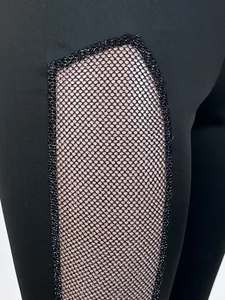 Detailed close-up showing the sexy mesh splicing and glitter trim on a black jumpsuit