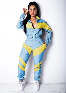 Two-piece color-block tracksuit featuring light blue and yellow paneled jacket and pants