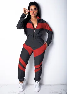 Full view of a stylish charcoal grey and red color-blocked windbreaker tracksuit for women