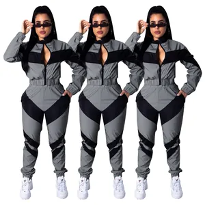 Two-piece women's grey and black color block windbreaker tracksuit with a full zip top.