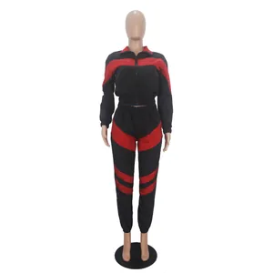 Detailed front view of a black and red color-blocked two-piece windbreaker tracksuit