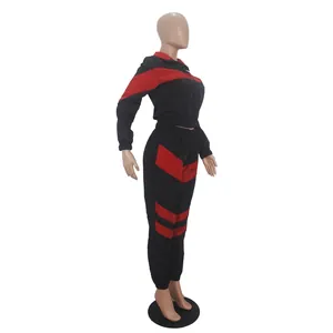 Side view of black and red color block two-piece windbreaker tracksuit set for women