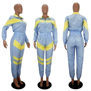 Three-angle view of a light blue and yellow color block women's windbreaker tracksuit