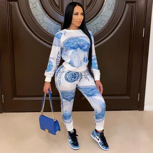 Detail of women's blue currency print two-piece sweatshirt and jogger set on model