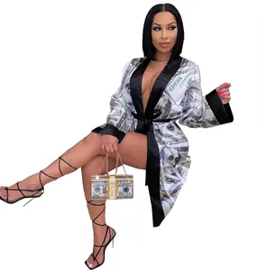 Dettaglio della sexy vestaglia in raso con stampa dollaro, finiture nere e borsa coordinata.