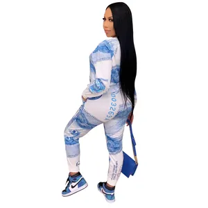 Close-up detail of women's fashion two-piece tracksuit with blue dollar bill print