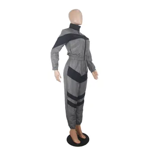 Professional detail view of a grey and black colorblock long sleeve windbreaker set