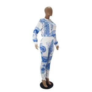 Detail view of women's two-piece tracksuit featuring a bold blue dollar bill print design